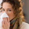 Young woman blowing her nose